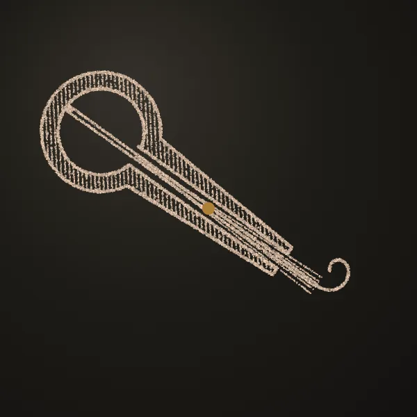 Jaw harp drawn in sand on a dark metal plate